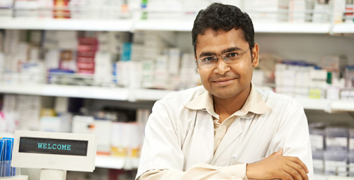 Male pharmacist smiling at camera